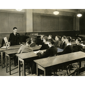 Classroom scene with professor showing students a diagram