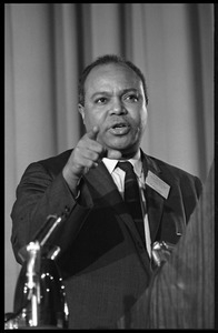 James Farmer speaking at the podium at the Youth, Non-Violence, and Social Change conference, Howard University