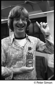 Phil Lesh: half-length portrait holding a bottle of Heineken beer