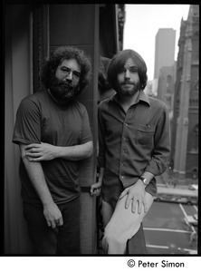 Jerry Garcia (left) and Bob Weir of the Grateful Dead standing on a balcony