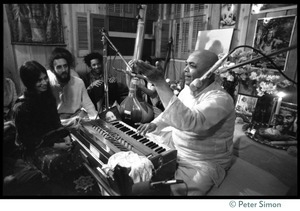 Amazing Grace members seated around an Indian harmonium player