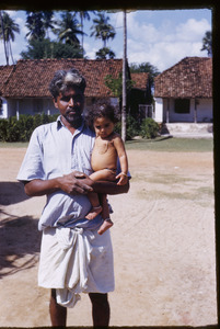 Man holding child in a village near Chennai