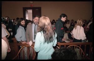 Scene inside the courtroom following acquittal in the CIA protest trial: Abbie Hoffman talks to Amy Carter (back to camera)