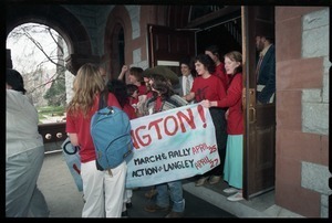 Defendants exit the Hampshire County courthouse following their acquittal in the CIA protest trial wearing 'Put the CIA on trial' t-shirts and carrying a banner reading 'On to Washington'