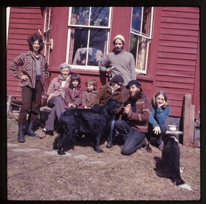 Nina Keller (far left) and her mother, Janice Frey (far right), and others, seated in front of the house at Montague Farm Commune with dogs