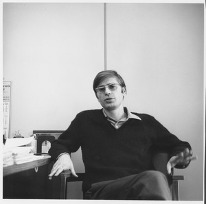 Paul Theroux seated in an office