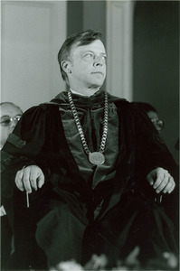 David C. Knapp seated in chair with academic regalia