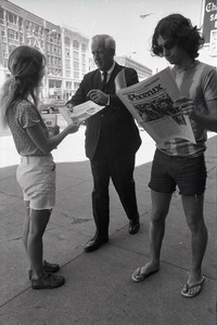 Boston Phoenix promotional photos: Phoenix hawker handing paper to man, Stephen Davis (r) reading