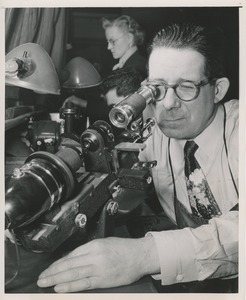 William Murphy working on optical lens grinding equipment