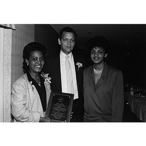 Carmen Pola poses with her award and two others at a Community Awards Dinner on 26 October 1984