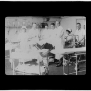 Nurses and doctors around an operating table