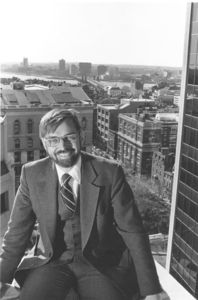Suffolk University Dean Richard M. McDowell (SOM, 1974-1991), seated with downtown Boston in background
