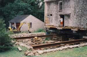 Sliding the barn into place on a new fieldstone foundation