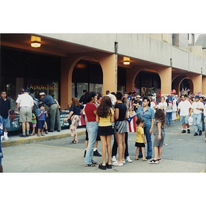 Festival goers in the street and browsing at booths at Festival Betances.
