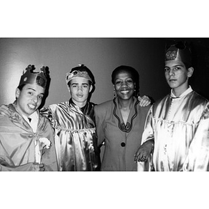Three boys dressed as the Three Kings pose with unidentified woman.