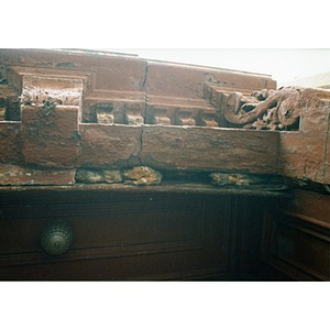 Crumbling exterior molding resting on a dresser.