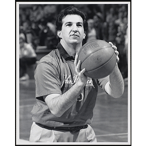 Joe Malone, former Treasurer and Receiver-General of Massachusetts, holding a basketball and looking up at a fund-raising event held by the Boys and Girls Clubs of Boston and Boston Celtics