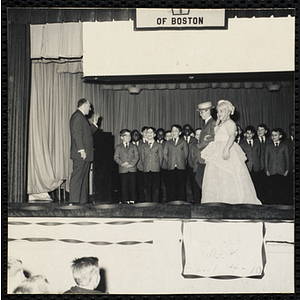 Boys' Club band playing on the stage at a Boys' Club Week celebration event. A caption on the back of the photograph states "The Revels rock 'n roll"