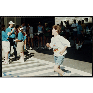 A boy runs in the Battle of Bunker Hill Road Race