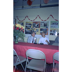 Henry Wong talks with a guest at a Chinese Progressive Association anniversary event