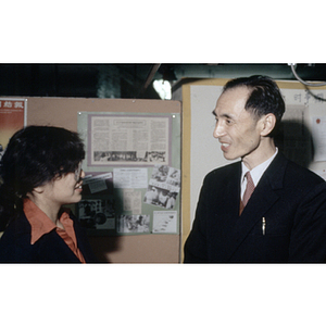 Member of the Chinese Progressive Association speaks to a visiting Chinese diplomat at the organization's office in Boston