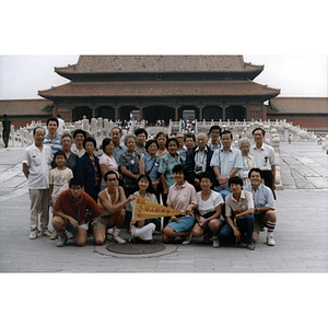 Association members pose for a group photograph in front of a building during a trip to China