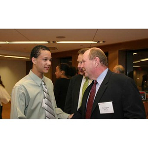 Odalis David Polanco converses with Ted English at the Torch Scholars dinner