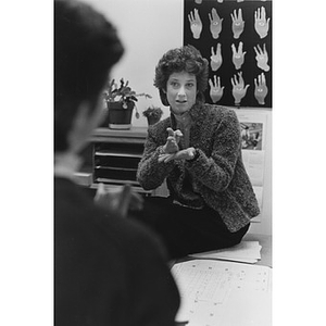 A woman teaching sign language