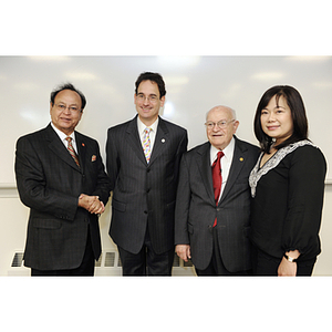 Dr. George J. Kostas , center right, and David E. Luzzi, center left, pose with a man and a woman at the groundbreaking ceremony