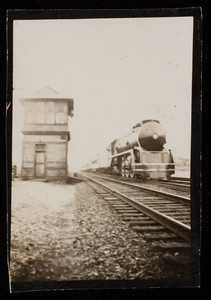 Train moving past a signal tower along railway at Cape Cod Canal