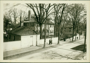 Exterior view of Langdon House, Portsmouth, N.H., showing outbuilding (garage? stable?) and people walking on the sidewalk.