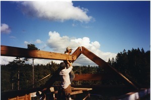 Setting the ridge beam in place on Trinidad home