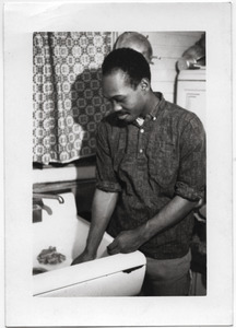 Bob Smith (SNCC worker from Brookhaven, Miss.) washing dishes