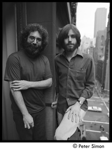 Jerry Garcia (left) and Bob Weir of the Grateful Dead standing on a balcony