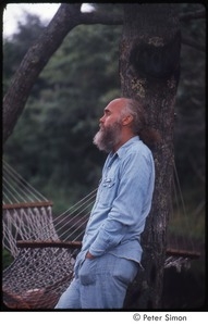 Ram Dass leaning on a tree