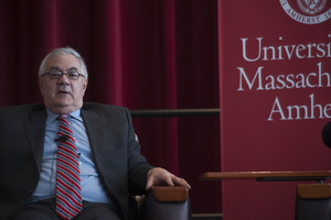 Congressman Barney Frank seated on the Student Union Ballroom stage, UMass Amherst, during his book event