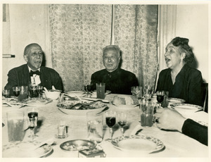 W. E. B. Du Bois and Shirely Graham Du Bois with unidentified Chinese dignitary singing at farewell dinner hosted by China's Peace Council