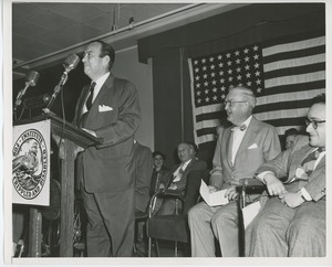 Unidentified speaker on stage at Institute Day