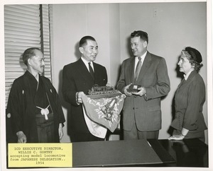 Willis C. Gorthy accepting model locomotive from Japanese delegation