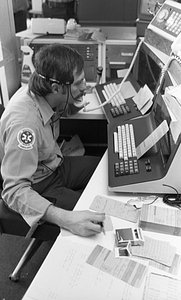 Unidentified Emergency Medical Technician wearing headset in Boston Police Dispatch Operations Center