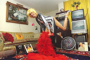 A Photograph of Marlow Monique Dickson Posing in a Sequin Dress with a Red Feather Boa
