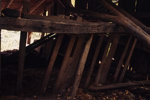Moon Barn interior in Moon Lot - Primmer Farm. Wooden cow stanchions on west side of barn.