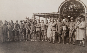 Group of soldiers posing for a photo outside a canteen