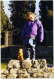 Maya Sommer and stuffed animal camel, Cammy, among Etruscan ruins in Fiesole