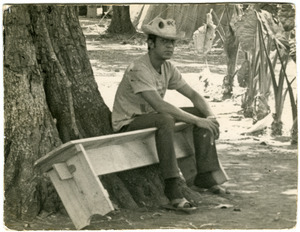 Postcard of Renato, Cuban jefe of work brigade, seated on bench (postcard from Sandra Rice inviting Lillydahl to festival on Cambridge Common