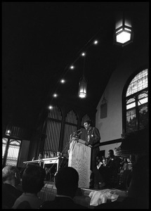 Stokely Carmichael speaking at the podium at the Youth, Non-Violence, and Social Change conference, Howard University