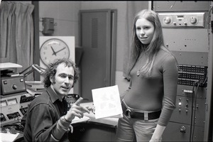 Richard Safft and unidentified woman with copy of Free Spirit Press magazine in radio broadcast studio