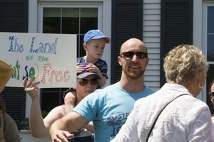 Pro-immigration protesters and signs outside the Chatham town offices building, one with a sign reading 'The land of the (not so) free' : taken at the 'Families Belong Together' protest against the Trump administration's immigration policies