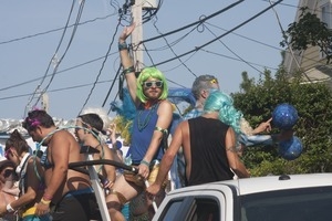 Parade marchers waving from atop a float : Provincetown Carnival parade