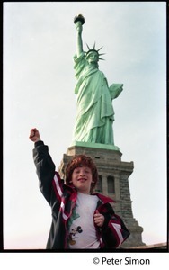 Statue of Liberty: view from the front, with child, raised fist, standing in foreground